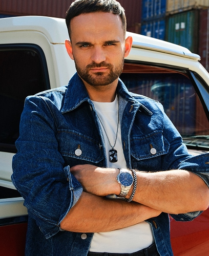 Bartosz Zmarzlik presenting Aztorin jewellery and a watch