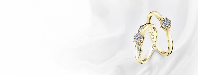 two rings in a shade of yellow gold with diamonds