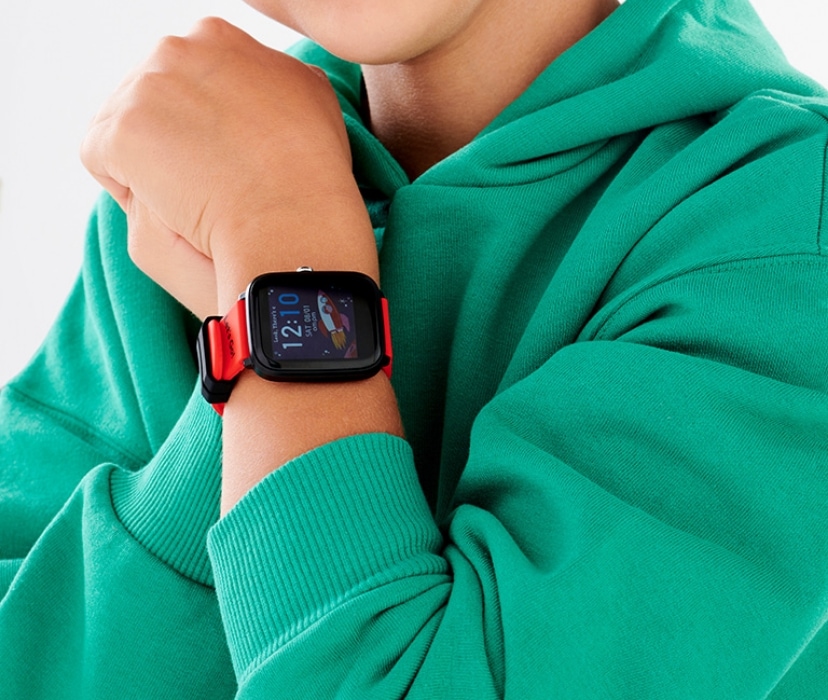 a watch with an orange band on a child's hand